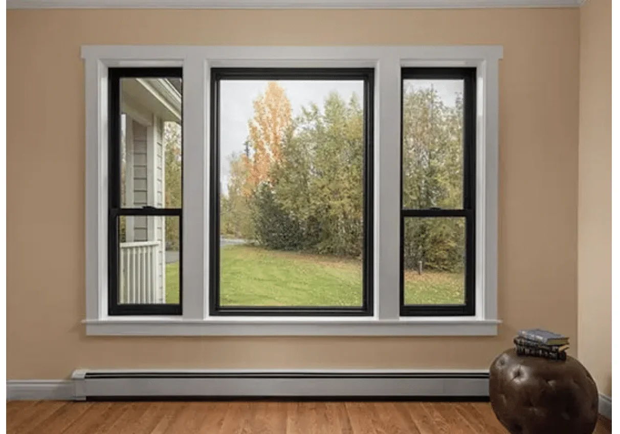 Modern black-frame windows showcasing a view of green foliage and trees, emphasizing energy efficiency and aesthetic appeal, relevant to Engstrom's window installation services in Minong, WI.